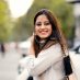 Outdoor image of young Happy woman having fun outside, she is waving her long hairs in air and making facial expression. Horizontal composition with copy space.